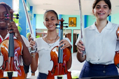 First year students at the Alejandro García Caturla Elementary School of Music receive new violins